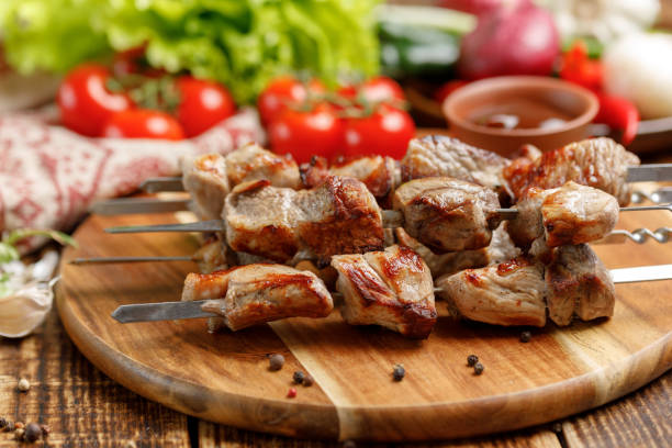 istock Juicy kebabs from pork. Meat cooked on open fire and fresh vegetables. 953787040