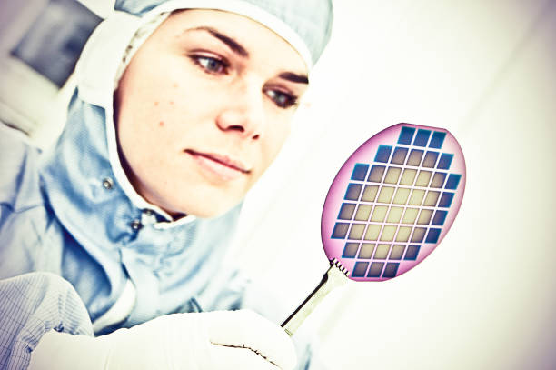 Female Scientist Carefully Inspect A Silicon with Square Pixel Detectors Silicon Wafer Under Cleanroom Fabrication photodiode stock pictures, royalty-free photos & images