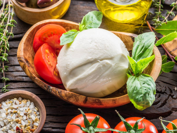 istock Buffalo mozzarella in the wooden bowl on the table. 953789256