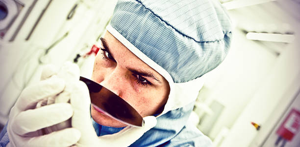 Female Scientist Carefully Inspect A Silicon with Square Pixel Detectors Silicon Wafer Under Cleanroom Fabrication photodiode stock pictures, royalty-free photos & images