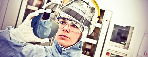 Female Scientist Carefully Inspect A Silicon with Square Pixel Detectors Silicon Wafer Under Cleanroom Fabrication photodiode stock pictures, royalty-free photos & images