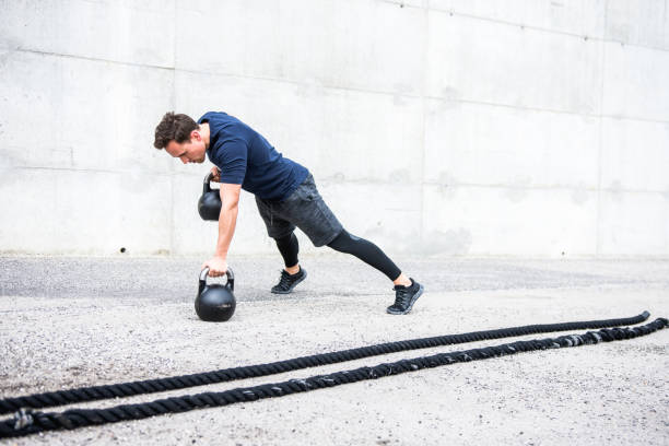 istock Athlete exercising with kettlebells outdoors 953793538
