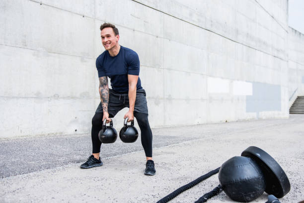 istock Man exercising with kettlebells outdoors 953793556