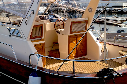 The yacht cabin  with a steering wheel and other controls.