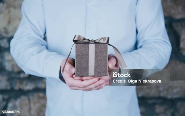 Male Hands Holding A Gift Stock Photo - Download Image Now - Gift, Men, Giving
