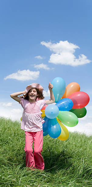 istock Girl playing with balloons on meadow 95380080