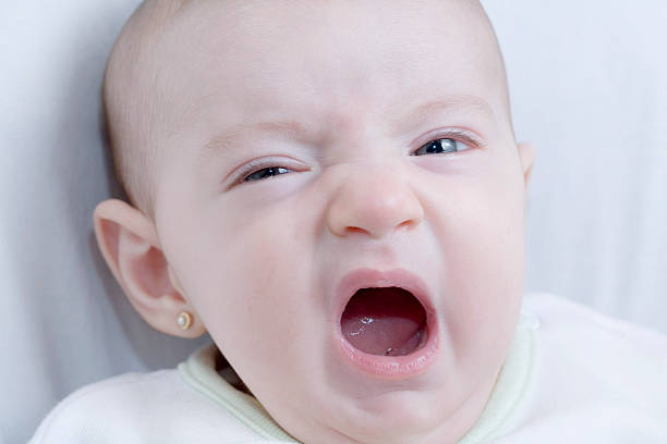 istock Baby yawning in bed 95380091