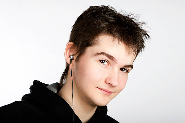 young cute boy listens music stock photo
