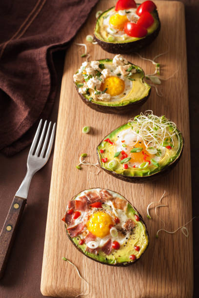 istock eggs baked in avocado with bacon, cheese, tomato and alfalfa sprouts 953805424