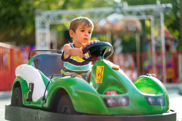 istock bored little boy in toy car 953806388