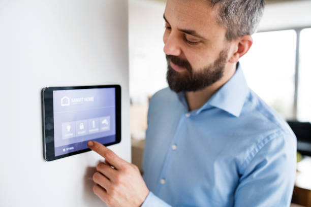 istock A man pointing to a tablet with smart home screen at home. 953806652
