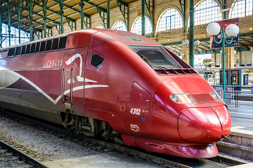 Paris, France - April 6, 2018: View of the locomotive of a Thalys high speed train, built by Alstom and run by the european consortium Thalys International, stationing in Paris Gare du Nord station.