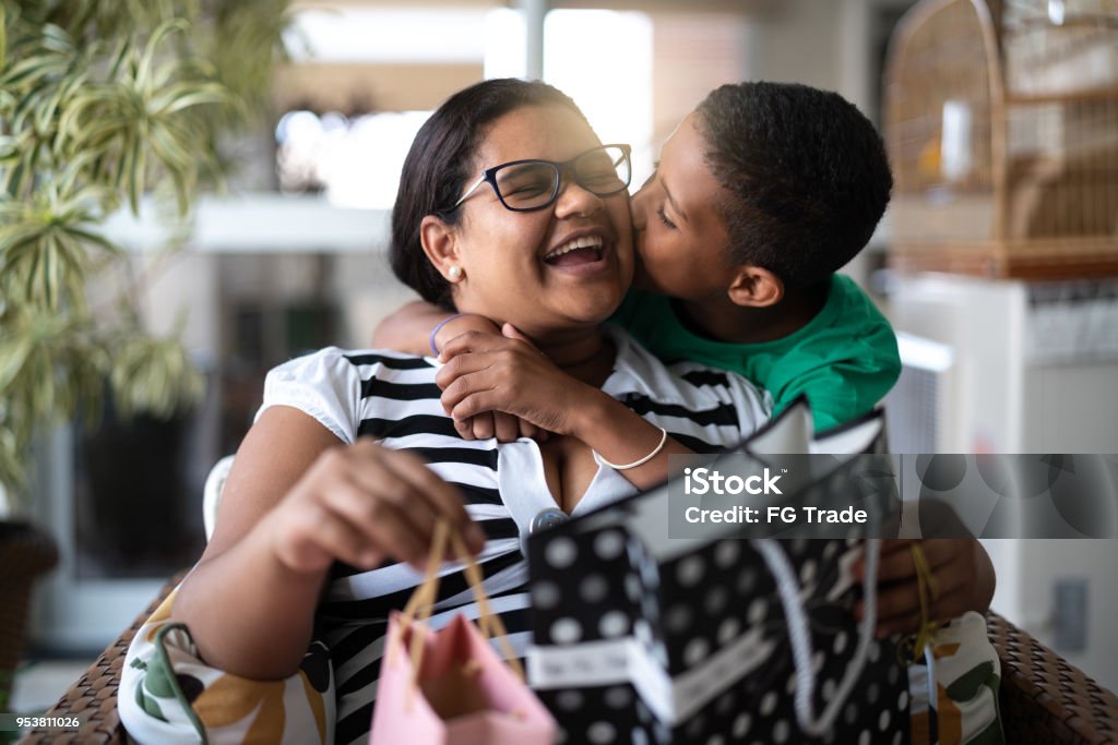 Mother and son embracing and receiving gifts - Mothers Or Children's Day I love my Family Mother Stock Photo