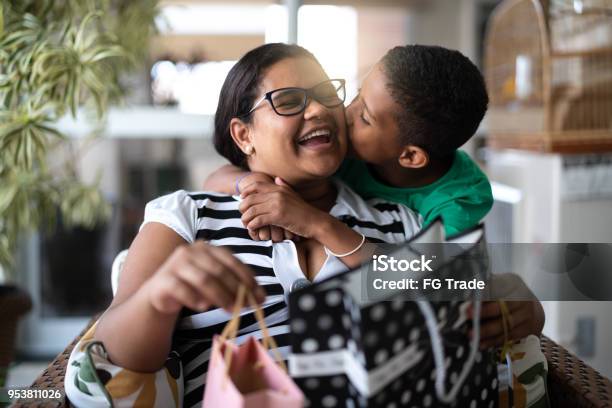 Mother And Son Embracing And Receiving Gifts Mothers Or Childrens Day Stock Photo - Download Image Now