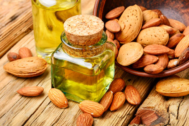 istock Almond oil in bottle and nuts 953814644