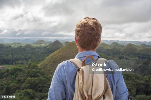 Man Traveling Contemplates Chocolate Hills Of Bohol Philippines Stock Photo - Download Image Now