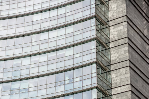 istock modern blue glass wall of office building 953819382
