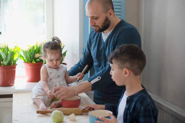 istock Dad with his little son and daughter baking together 953820188