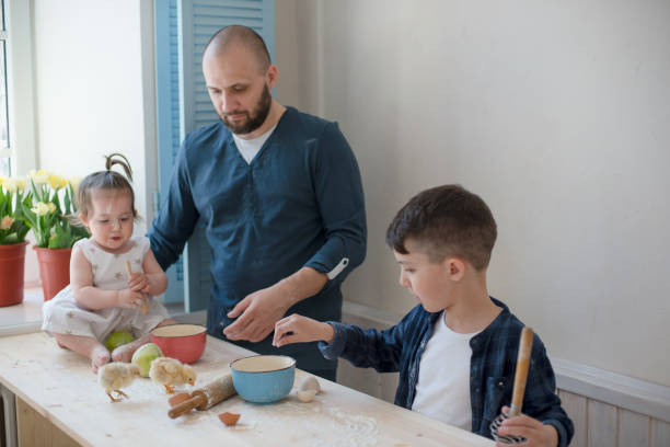 istock Dad with his little son and daughter baking together 953820212