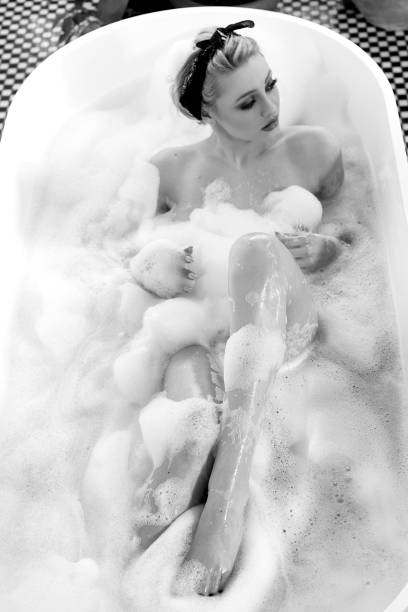 istock Sensual blonde woman taking a bath. 953829640