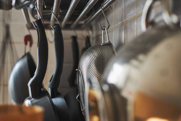 istock Untidy home details, rack with hanging cooking pots 953831036