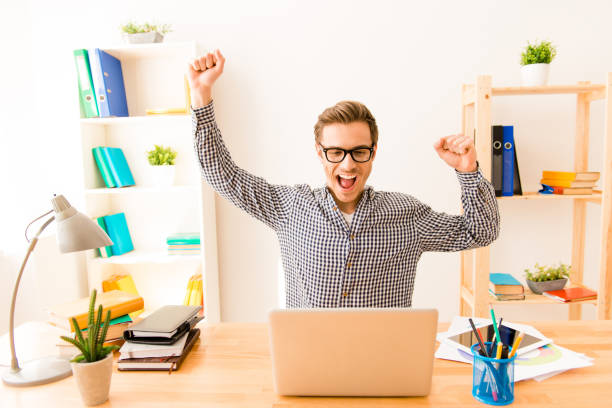istock Happy successful young businessman triumphing with raised hands 953831406