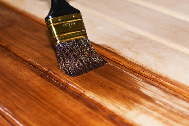 istock Painting a wooden surface with brushes and paint , copy space . 953834518