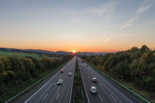 istock The road traffic on a motorway at sunset 953835114