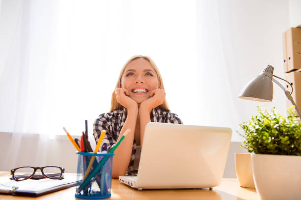 istock Pretty cheerful successful young woman dreaming in office 953835528