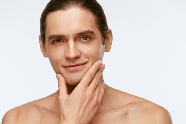 istock Men Face Care. Man Touching Smooth Skin After Shaving 953838588