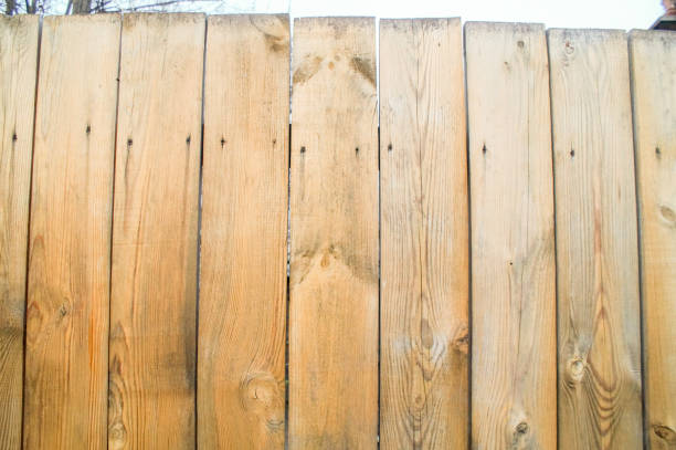 istock A fence made of unpainted boards 953842734