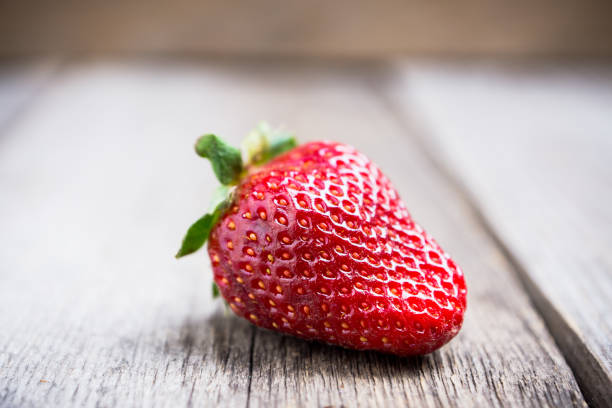 istock Red ripe strawberry on the rustic background 953843898