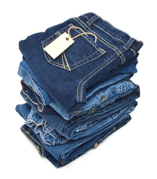 istock Stack of blue jeans and blank card on white background 953844888