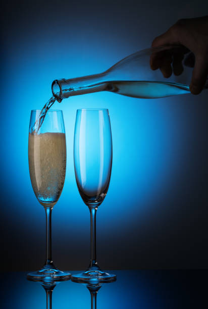 Champagne is poured from the bottle into glasses