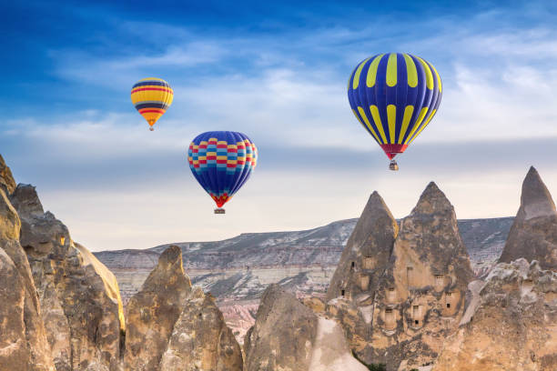 istock Three bright multi-colored hot air balloons flying in sunsrise sky Cappadocia, Turkey 953854120