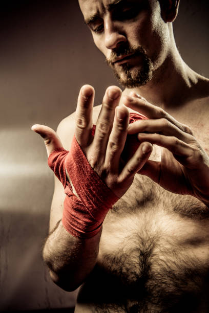 istock Adult Boxer Tying Protective Cloth Aroung his Wrists 953854850