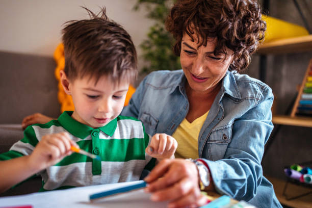 istock Mother and son coloring together 953854886