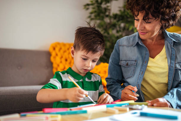 istock Mother and son coloring together 953854924