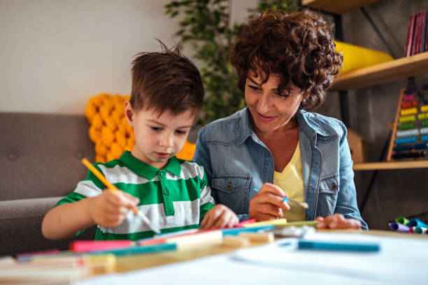 istock Mother and son coloring together 953855272