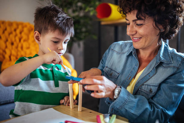 istock Mother and son coloring together 953855448