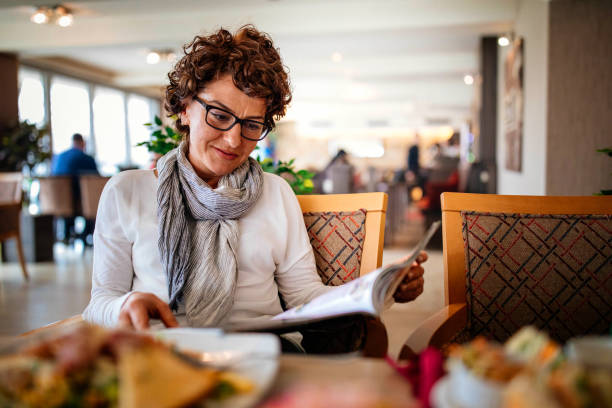 istock Reading favorite magazine at a restaurant 953858512