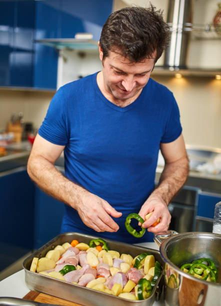 istock Man cooking at home 953859460