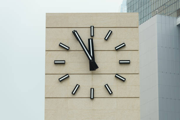istock Retro alarm clock with five minutes to twelve o'clock. 953859660