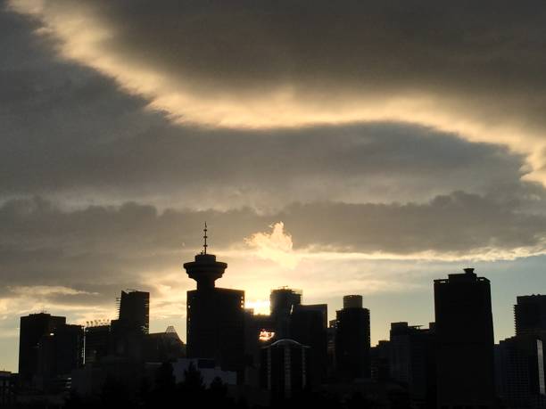 istock White streaks in clouds over silhouette of Vancouver Skyline 953859984