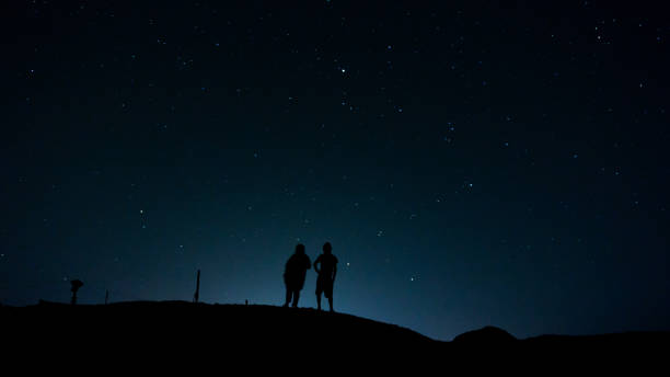 istock Two friends stargzaing in the desert 953869200