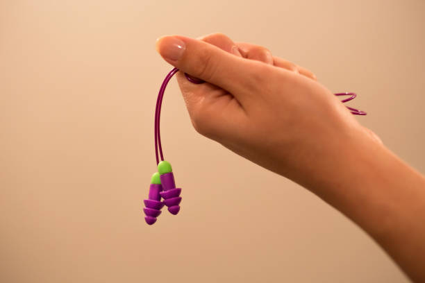 istock woman holding earplugs. 953870128