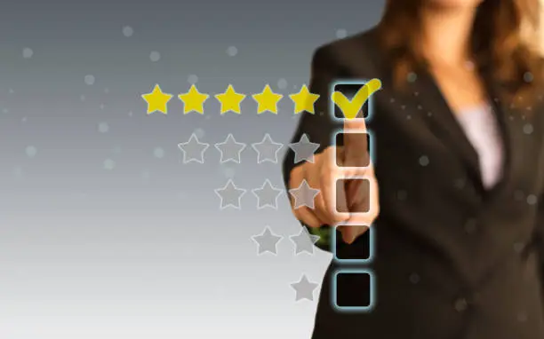 Photo of Businesswoman touching five stars