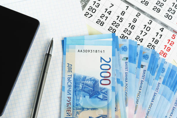 New Russian two thousand bills, calendar, notebook and smartphone