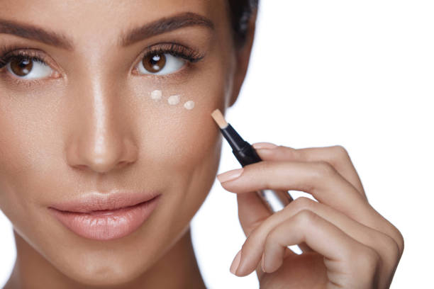 istock Cosmetics. Beautiful Woman Applying Concealer, Doing Makeup 953873292