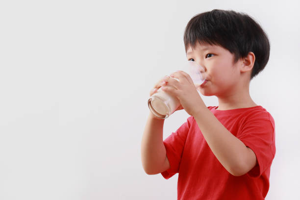 Young boy drinking milk stock photo